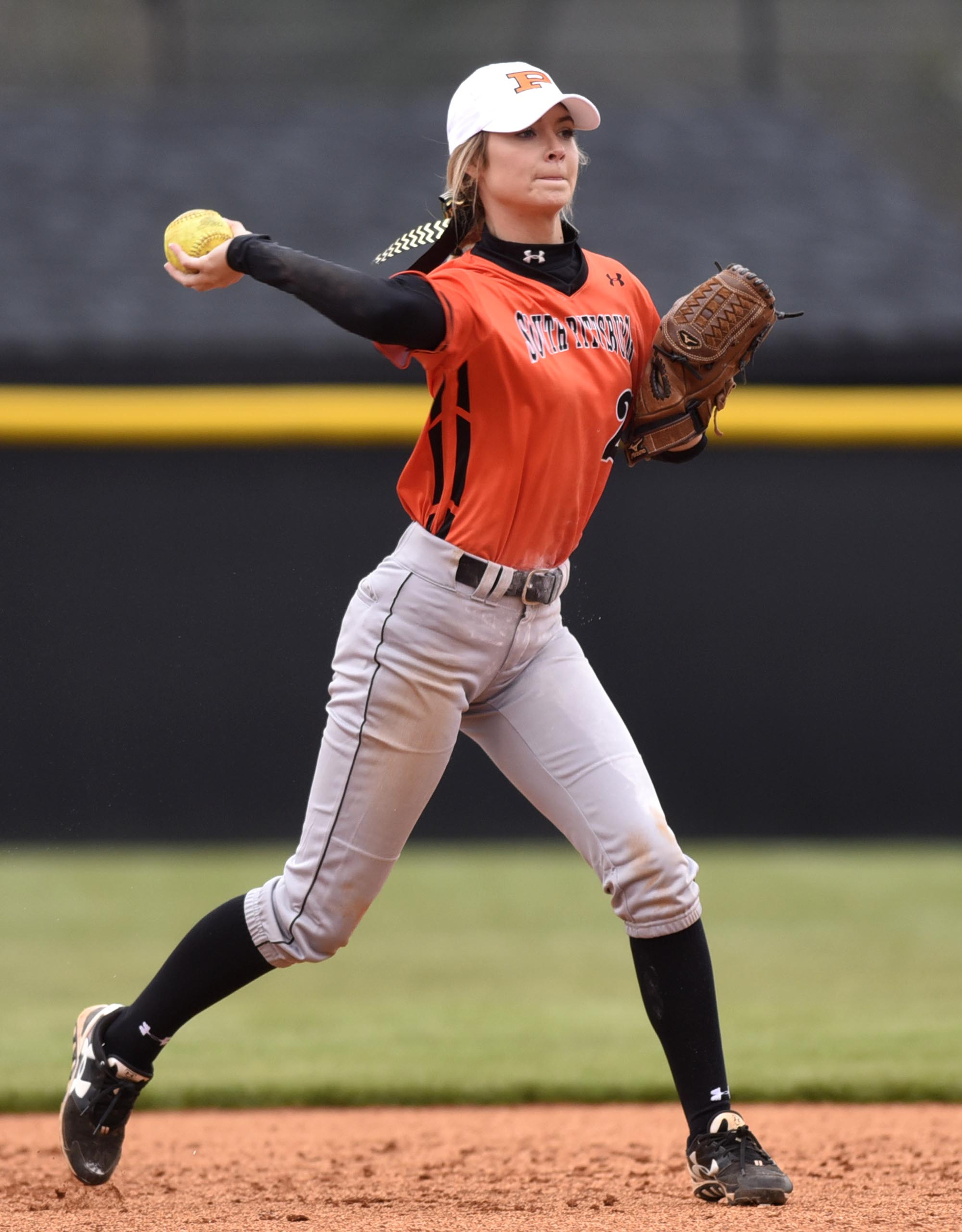 Staff Photo by Robin Rudd South Pittsburg's second baseman Victoria Grider (22), shown throwing to first base in a recent game, is in her senior season playing for her father, Vic.