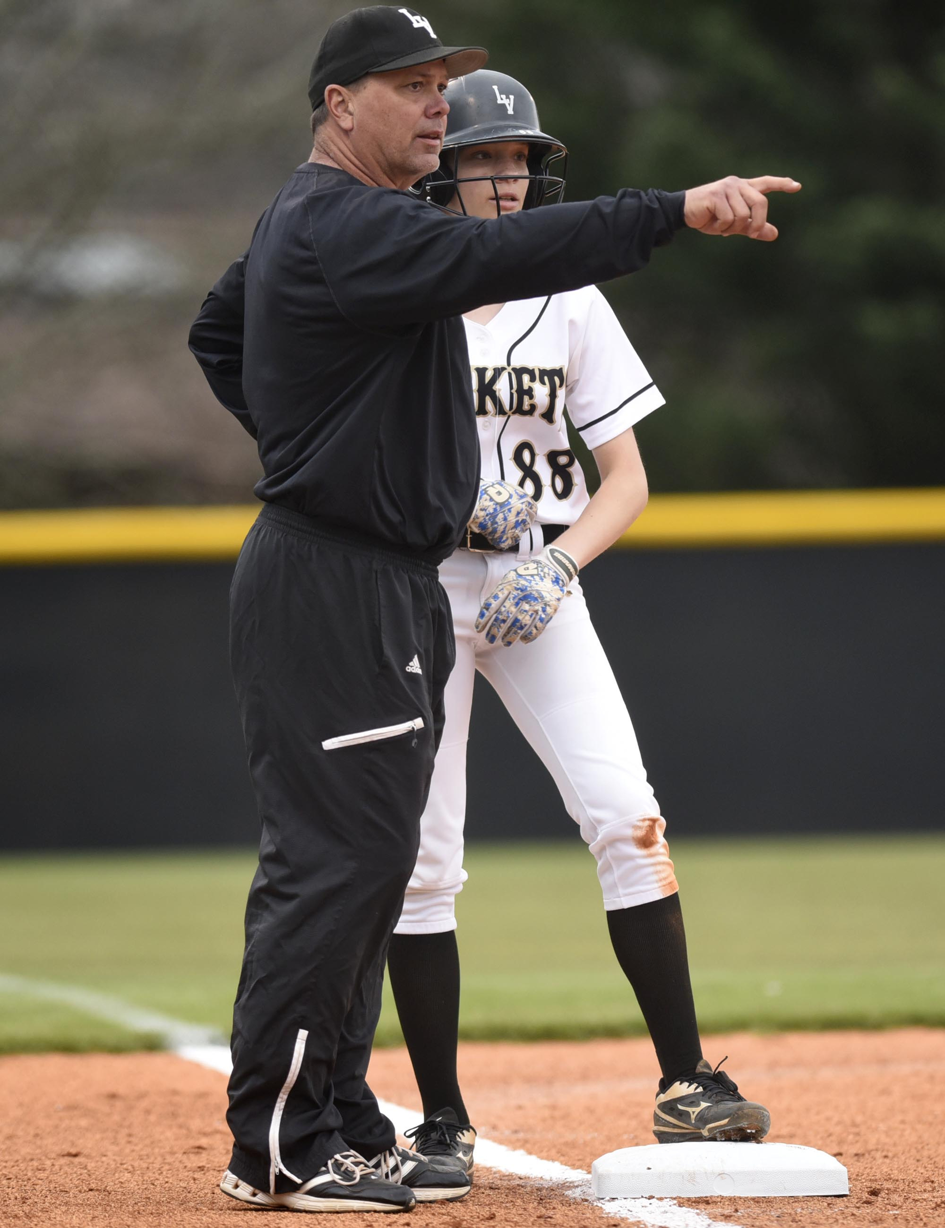 Staff Photo by Robin Rudd Lookout Valley coach David Dinger gives instructions to baserunner Savannah Rains (88). Dinger is a longtime baseball and football coach now coaching daughter Katie in softball.