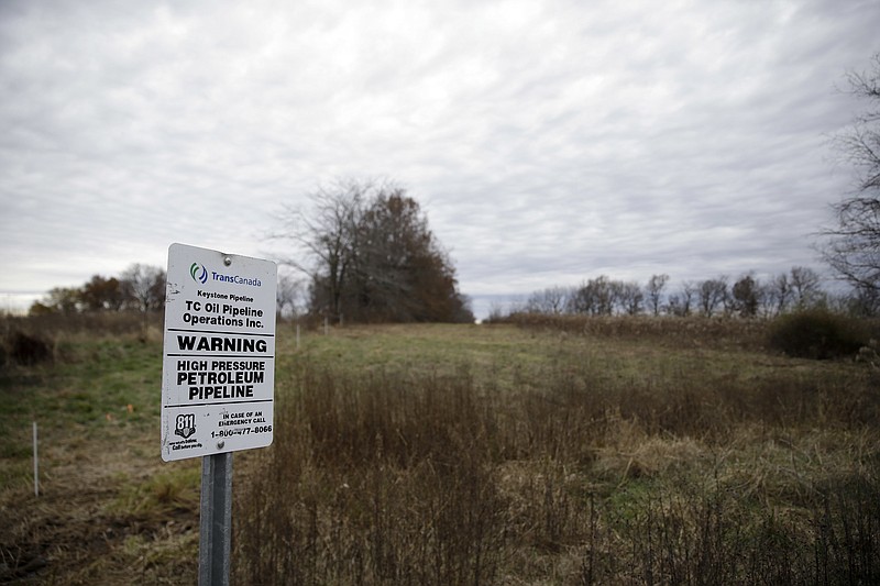 
              FILE - In this Nov. 20, 2015 file photo, a sign marking the location of the TransCanada Keystone underground oil pipeline, running under farmland is seen in Moberly, Mo. (AP Photo/Jeff Roberson, File)
            