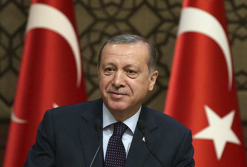 
              Turkey's President Recep Tayyip Erdogan smiles,  during a meeting with local media representatives, in Ankara, Turkey, Wednesday, March 22, 2017. Tensions between Turkey and Europe have boiled in recent weeks, but acrimony over Turkey's belief that some European countries are harboring suspected terrorists has festered for years. Erdogan criticized Germany Wednesday for allowing a weekend rally of Kurds, some of whom expressed support for a jailed rebel leader in Turkey.(Yasin Bulbul/Presidential Press Service, Pool Photo via AP)
            