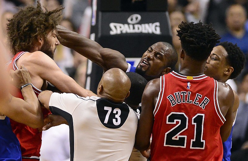 
              Toronto Raptors' Serge Ibaka, center, strikes Chicago Bulls' Robin Lopez, left, during a scuffle in the second half of an NBA basketball game in Toronto, Tuesday, March 21, 2017. (Frank Gunn/The Canadian Press via AP)
            
