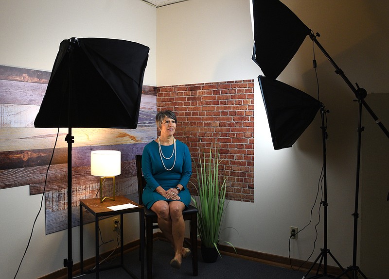  Julie Baumgardner, CEO of First Things First, chats Friday, March 17 while waiting to create a video spot at First Things First.