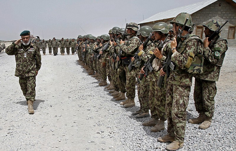 
              FILE - In this Thursday, June 13, 2013 file photo, Afghan National Army soldiers stand in position, in the Sangin district of Kandahar province, southern Afghanistan. Afghan officials said Thursday, March 23, 2017, that the Taliban have captured the Sangin district in southern Helmand province while in the country's north, an Afghan officer turned his rifle on sleeping colleagues, killing nine policemen. The taking of Sangin district, once considered the deadliest battlefield for British and U.S. troops in Afghanistan, marks the culmination of the insurgents' year-long push to expand their footprint in the Taliban heartland of Helmand. (AP Photo/Allauddin Khan)
            