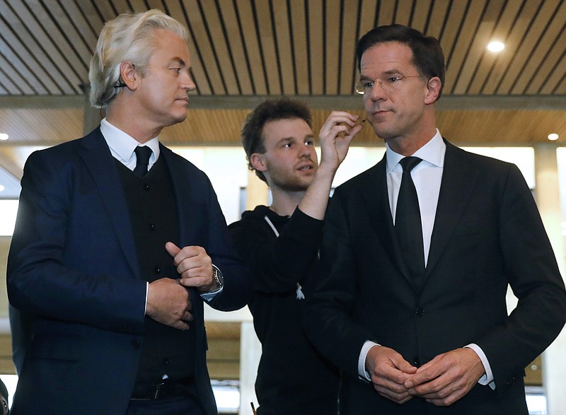 
              FILE - In this March 13, 2017 file photo, Dutch Prime Minister Mark Rutte, right, and right-wing populist leader Geert Wilders, get their microphones installed prior to a national televised debate in Rotterdam, Netherlands. Wilders said on Wednesday, March 22, 2017, that political parties discussing the makeup of the next Dutch ruling coalition are shutting him out and sidelining 1.3 million people who voted for his party in last week’s parliamentary election. (Yves Herman/Pool via AP, File)
            