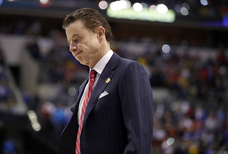 
              FILE - In this Sunday, March 19, 2017, file photo, Louisville head coach Rick Pitino walks off the court after a 73-69 loss to Michigan in a second-round game in the men's NCAA college basketball tournament in Indianapolis. The NCAA is standing by its allegations against the Louisville men's basketball program and Pitino, saying the coach failed to notice "red flags" in activities by a former staffer who an escort says hired dancers for sex parties with recruits and players. (AP Photo/Jeff Roberson, File)
            