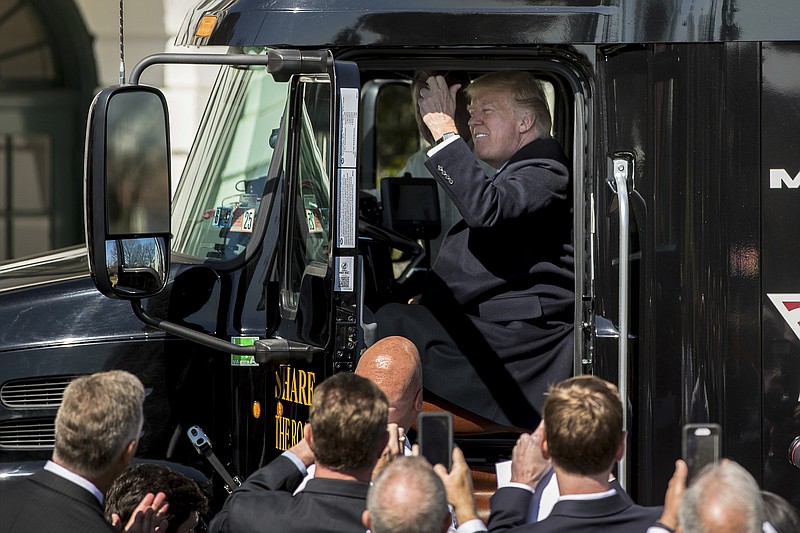 
              President Donald Trump honks the horn of an 18-wheeler truck while meeting with truckers and CEOs regarding healthcare on the South Lawn of the White House in Washington, Thursday, March 23, 2017. (AP Photo/Andrew Harnik)
            