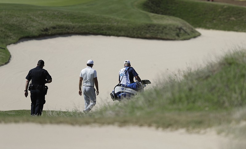 
              Defending champion Jason Day, center, of Australia, center, down the seventh hole after he conceded to Pat Perez after six holes of play during round-robin play at the Dell Technologies Match Play golf tournament at Austin County Club, Wednesday, March 22, 2017, in Austin, Texas. Day also withdrew from the tournament. (AP Photo/Eric Gay)
            
