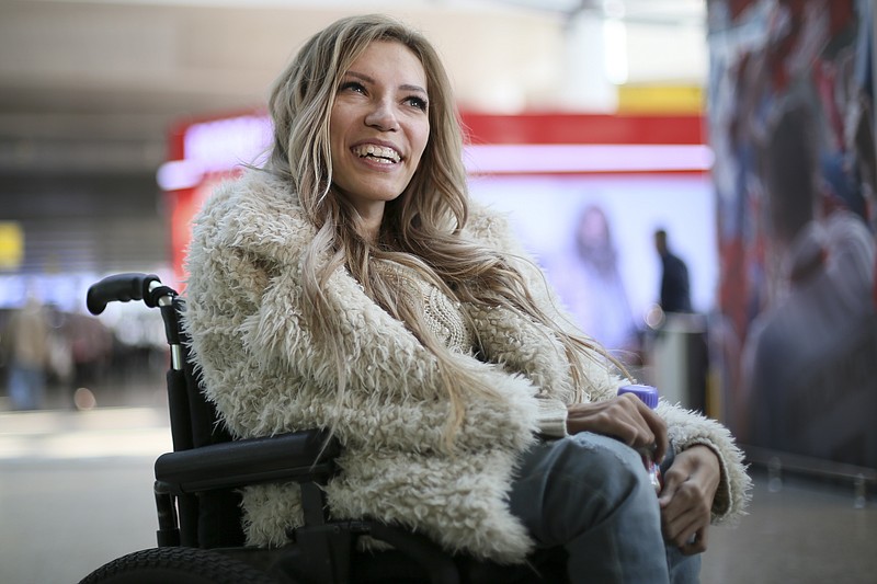 
              In this photo taken on Tuesday, March 14, 2017, Russian singer Yulia Samoylova who was chosen to represent Russia in the May 11-13 Eurovision Song Contest being held in the Ukrainian capital Kiev, poses while sitting in a wheelchair at Sheremetyevo airport outside Moscow, Russia. Ukraine's security service has banned Russia's 27-year old contestant Samoylova who has been wheelchair-bound since childhood, from this year's Eurovision song contest.(AP Photo/Maria Antipina)
            