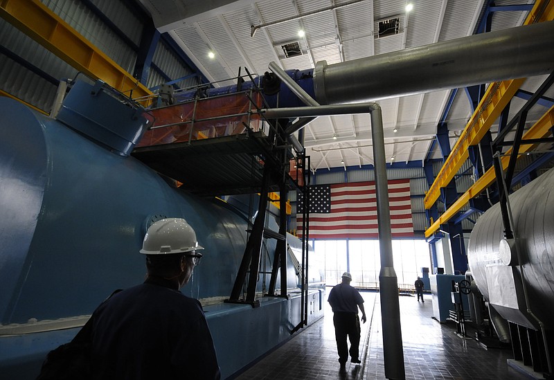 Workers walk past the Unit 2 turbine at Watts Bar Nuclear Plant.