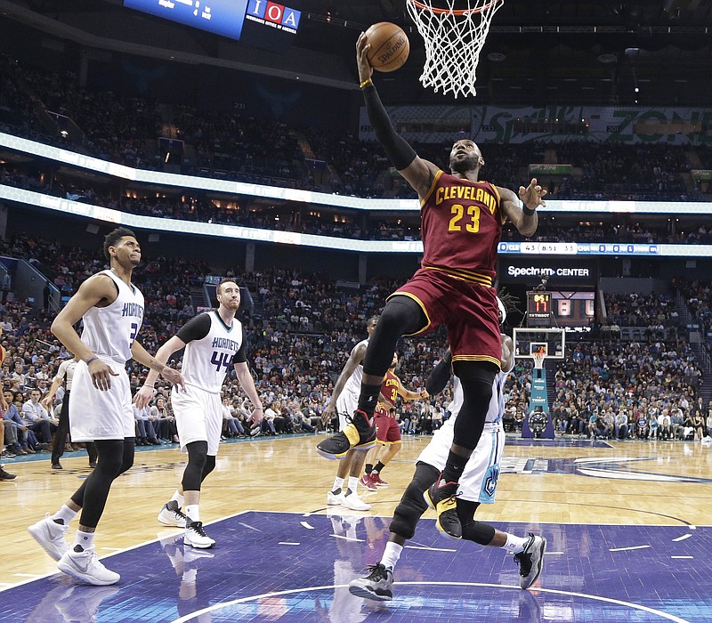 
              Cleveland Cavaliers' LeBron James (23) drives to the basket against the Charlotte Hornets during the first half of an NBA basketball game in Charlotte, N.C., Friday, March 24, 2017. (AP Photo/Chuck Burton)
            