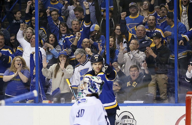 
              St. Louis Blues left wing Magnus Paajarvi points to teammate Patrik Berglund after Berglund assisted on Paajarvi's second goal of the night against Vancouver Canucks goaltender Ryan Miller, during the third period of an NHL hockey game Thursday, March 23, 2017, in St. Louis. (Chris Lee/St. Louis Post-Dispatch via AP)
            