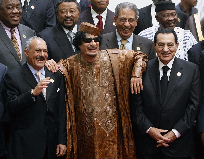 
              FILE - In this Oct. 10, 2010 file photo, Libyan leader Moammar Gadhafi, center, with Egyptian President Hosni Mubarak, right, and his Yemeni counterpart Ali Abdullah Saleh, left, pose during a group picture with Arab and African leaders during the second Afro-Arab summit in Sirte, Libya. Egypt's ousted former leader Hosni Mubarak was released after six years in prison on Friday, March 24, 2017, but he is not the only ruler in the Middle East to be caught up in Arab Spring uprisings that swept across the region since 2011. Exiled, killed or fighting for their lives, here is a look at the fate of other Arab leaders.(AP Photo/Amr Nabil, File)
            