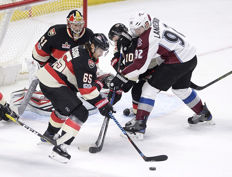 
              FILe - In this March 2, 2017, file photo, Ottawa Senators' Erik Karlsson (65) keeps the puck away from goalie Craig Anderson (41) and Colorado Avalanche's Gabriel Landeskog (92) during the second period of an NHL hockey game in Ottawa, Ontario. The Colorado Avalanche and Ottawa Senators will play two regular-season games in Sweden next season. The NHL and NHL Players’ Association on Friday, March 24, 2017,  announced their new “Global Series” games Nov. 10 and 11 in Stockholm .(Justin Tang/The Canadian Press via AP, File)
            