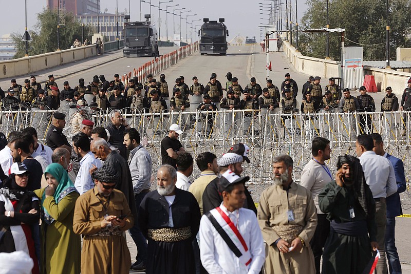 
              Iraqi riot police close a bridge leading to the heavily guarded Green Zone during a demonstration of supporters of Iraq's influential Shiite cleric Muqtada al-Sadr against corruption in Tahrir Square in Baghdad, Iraq, Friday, March 24, 2017. Al-Sadr has threatened to boycott the upcoming provincial elections, urging instead followers to join a "reform revolution." (AP Photo/Karim Kadim)
            