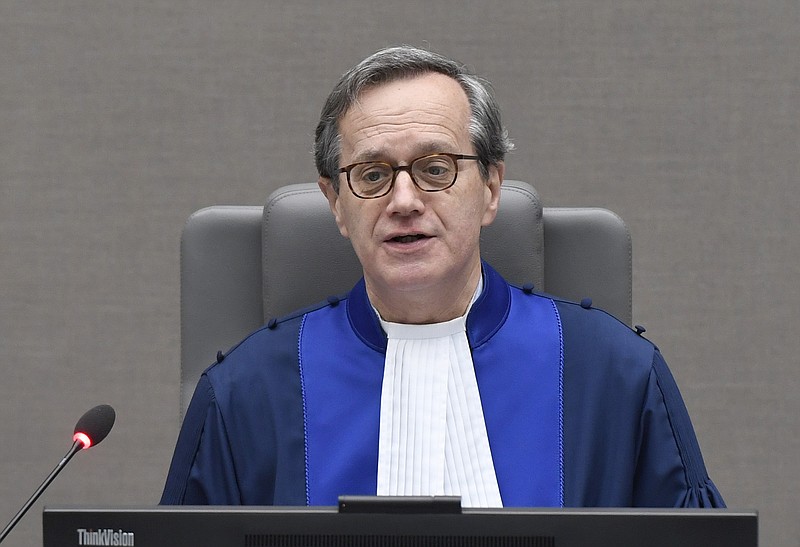 
              Presiding Judge Marc Perrin de Brichambaut opens the court session prior to delivering the order for reparations to victims in the Germain Katanga case at the International Criminal court in The Hague, Netherlands, Friday March 24, 2017. (Toussaint Kluiters POOL via AP)
            