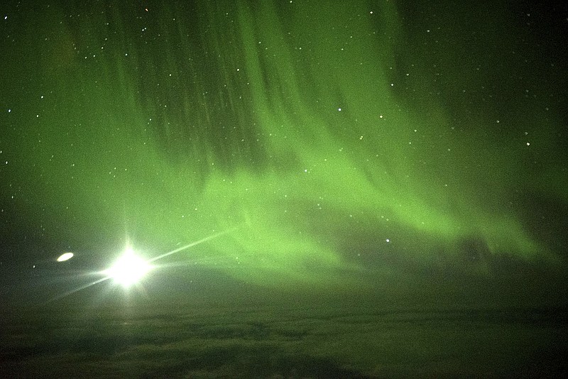 
              The Southern Lights are seen over the Southern Ocean near Antarctica from a chattered plane Friday, March 24, 2017. A charter plane that left Dunedin, New Zealand, late Thursday flew close to the Antarctic Circle to give the eager passengers an up-close look at the Aurora Australis, or Southern Lights. (Ian Griffin via AP)
            