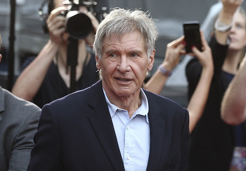 
              FILE - In this December 10, 2015 file photo, Harrison Ford greets fans during a Star Wars fan event in Sydney, Australia. Ford told an air traffic controller he was distracted and concerned about turbulence from another aircraft when he mistakenly landed his small plane on a taxiway at a Southern California airport in Feb. 2017. (AP Photo/Rob Griffith, File)
            