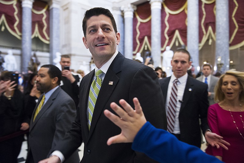 House Speaker Paul Ryan of Wis., passes a waving tourist as he walks from the House Chamber to his office on Capitol Hill in Washington, Friday, March 24, 2017, as the House nears a vote on their health care overhaul. (AP Photo/Cliff Owen)