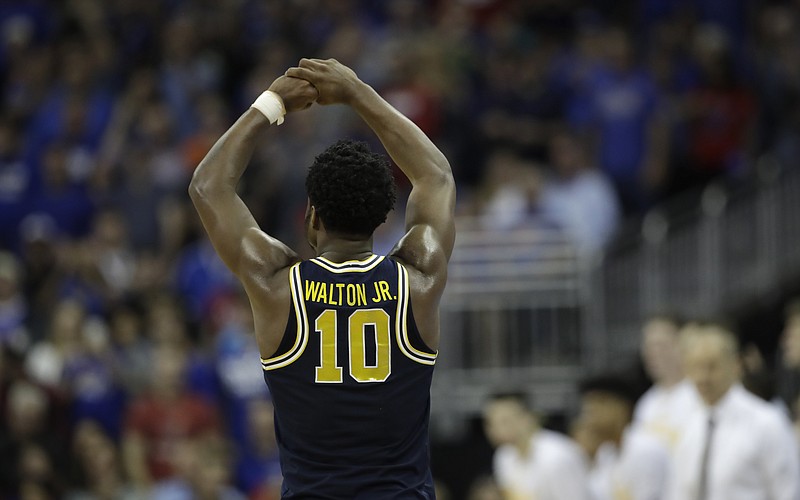 
              Michigan guard Derrick Walton Jr. reacts at the end of a regional semifinal against Oregon in the NCAA men's college basketball tournament, Thursday, March 23, 2017, in Kansas City, Mo. Oregon won 69-68. (AP Photo/Charlie Riedel)
            