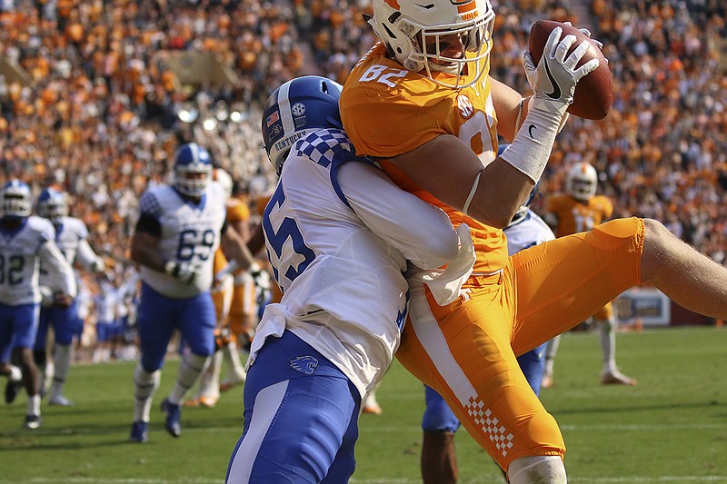 Tennessee's Ethan Wolf scores a touchdown as Kentucky's Marcus McWilson attempts to stop him during the Vols' 49-36 win last November at Neyland Stadium. Wolf is happy Larry Scott is still his position coach and now also the offensive coordinator.