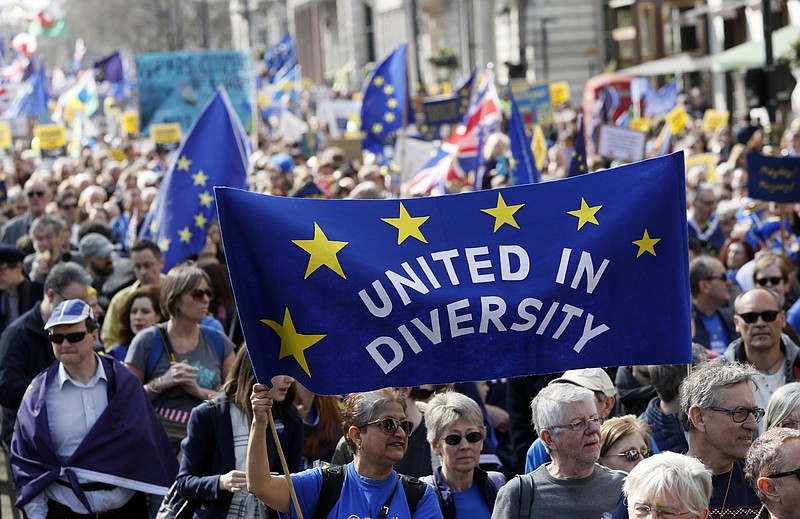 
              Anti Brexit campaigners carry flags and banners as they march towards Britain's parliament in London, Saturday March 25, 2017. Britain's Prime Minister Theresa May is expected to start the process of leaving the European Union on Wednesday March 29. (AP Photo/Kirsty Wigglesworth)
            