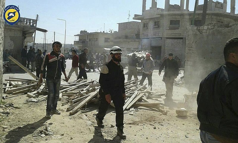 
              This photo provided by the Syrian Civil Defense group known as the White Helmets, shows Civil Defense workers and Syrian citizens inspecting damaged buildings after airstrikes hit Maarat al-Nuaman town, in Idlib province, Syria, Saturday, March 25, 2017.  (Syrian Civil Defense White Helmets via AP)
            