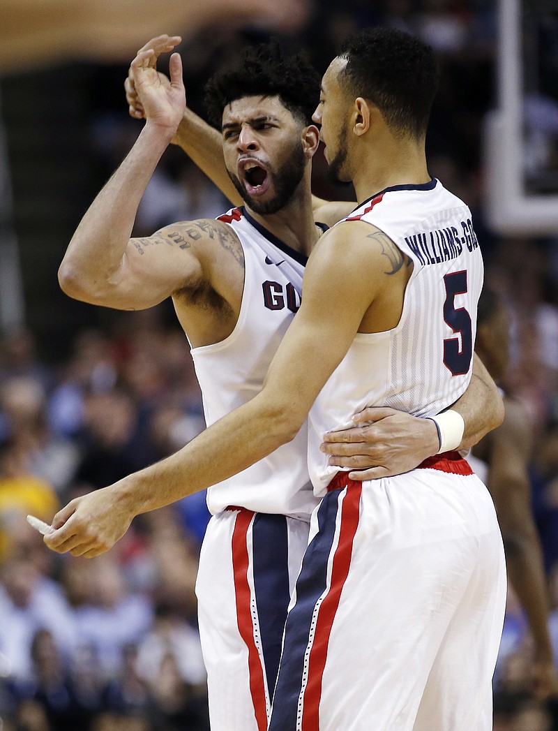
              Gonzaga guard Josh Perkins, left, celebrates with teammate Nigel Williams-Goss, right, after a win over West Virginia during the second half of an NCAA Tournament college basketball regional semifinal game Thursday, March 23, 2017, in San Jose, Calif. (AP Photo/Tony Avelar)
            