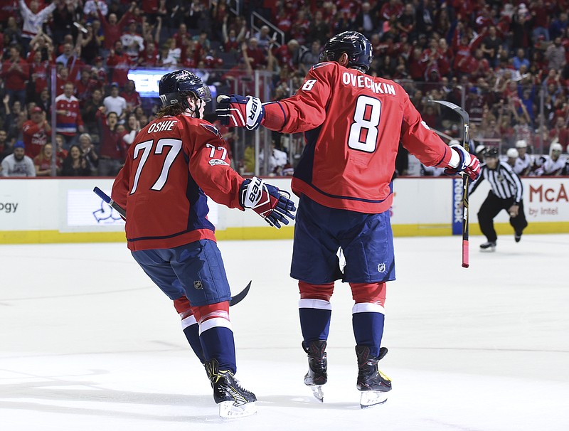 
              Washington Capitals left wing Alex Ovechkin (8) celebrates his goal with right wing T.J. Oshie (77) during the first period of the team's NHL hockey game against the Arizona Coyotes, Saturday, March 25, 2017, in Washington. (AP Photo/Molly Riley)
            
