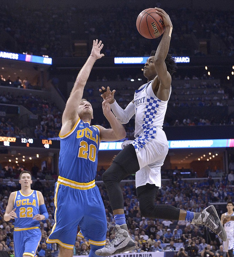 
              Kentucky guard De'Aaron Fox heads to the basket against UCLA guard Bryce Alford in the second half of an NCAA college basketball tournament South Regional semifinal game Friday, March 24, 2017, in Memphis, Tenn. (AP Photo/Brandon Dill)
            