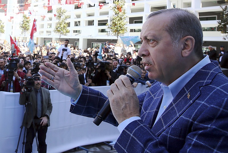 
              Turkey's President Recep Tayyip Erdogan addresses his supporters in Antalya, Turkey, Saturday, March 25, 2017. Erdogan on Friday has hit out at the head of Germany's intelligence service for comments suggesting that Berlin was not convinced over U.S.-based cleric Fethullah Gulen's role in Turkey's failed coup. Erdogan accused the BND foreign intelligence chief Bruno Kahl of making the remarks on behalf of Germany's leaders, whom he said backed Gulen's movement.(Kayhan Ozer/Presidential Press Service, Pool Photo via AP)
            