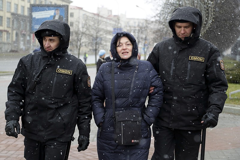 
              Belarus police detain a woman prior to an opposition rally in Minsk, Belarus, Saturday, March 25, 2017. Over the past two months, protests have broken out across the country of 9.5 million, sometimes attracting thousands — initially they were focused on the labor law but have grown to encompass calls for the resignation of President Alexander Lukashenko, whom critics call Europe's last dictator. (AP Photo/Sergei Grits)
            