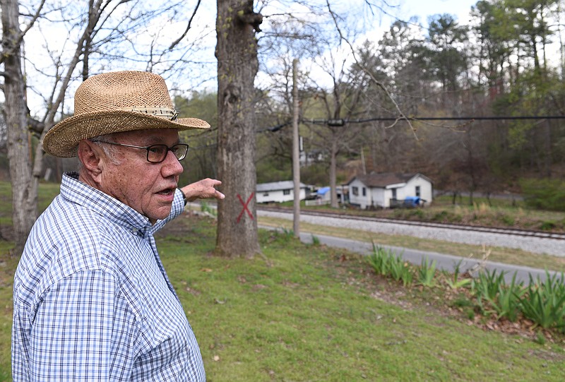 Richard McGibony stands Sunday, March 26, 2017 near a tree that will be taken down soon because it interferes with power lines. McGibony remembers sitting by the tree when he was a boy, watching the train carrying President Franklin D. Roosevelt.