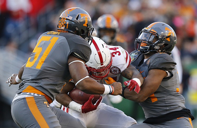 Tennessee defenders Kenny Bynum, left, and Darrin Kirkland, Jr., tackle Nebraska's Terrell Newby in the first half of the Vols' Music City Bowl game against the Nebraska Cornhuskers at Nissan Stadium on Friday, Dec. 30, 2016, in Nashville, Tenn. Tennessee won 38-24.