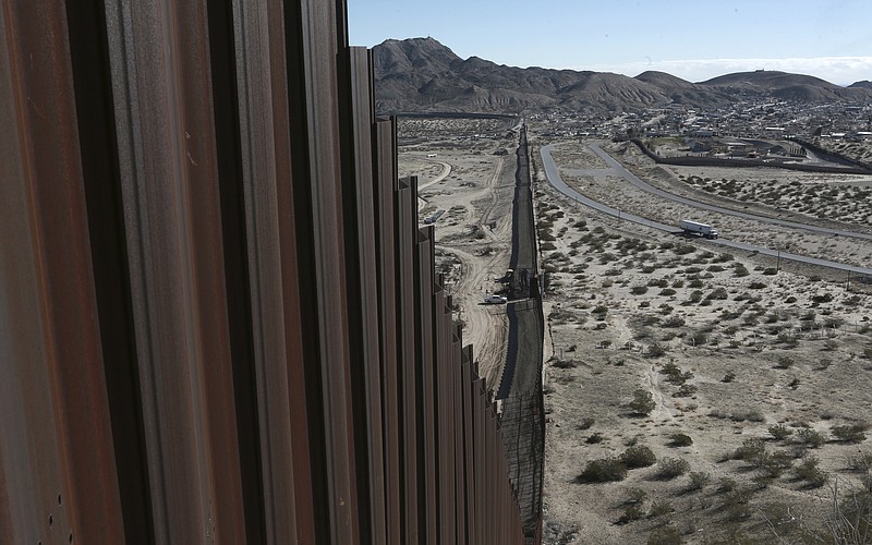 
              FILE - This Jan. 25, 2017, file photo shows a truck driving near the Mexico-US border fence, on the Mexican side, separating the towns of Anapra, Mexico and Sunland Park, New Mexico. President Donald Trump will face many obstacles in building his “big, beautiful wall” on the U.S.-Mexico border, including how to pay for it and how to contend with unfavorable geography and the legal battles ahead.  (AP Photo/Christian Torres, File)
            