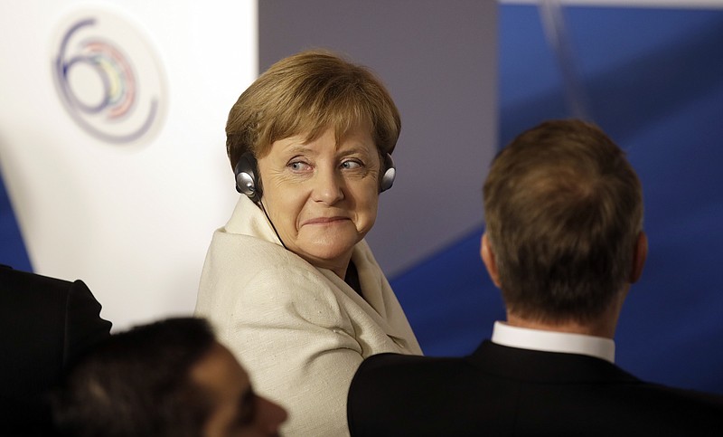 
              German Chancellor Angela Merkel, center, turns her head as she listens to the opening address during an EU summit meeting at the Orazi and Curiazi Hall in the Palazzo dei Conservatori in Rome on Saturday, March 25, 2017. European Union leaders were gathering in Rome to mark the 60th anniversary of their founding treaty and chart a way ahead following the decision of Britain to leave the 28-nation bloc. (AP Photo/Alessandra Tarantino)
            