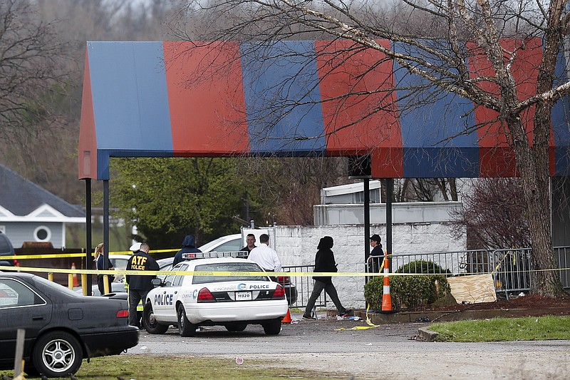 
              Members of the ATF and local police work at a crime scene at the Cameo club after a fatal shooting, Sunday, March 26, 2017, in Cincinnati. (AP Photo/John Minchillo)
            