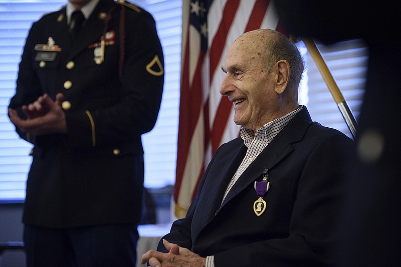 
              Oscar Davis Jr, a 92-year-old World War II veteran who served with the 1st Battalion, 505th Parachute Infantry Regiment, smiles on Saturday, March 25, 2017, after being awarded a Purple Heart medal for wounds suffered in Ardennes during the Battle of the Bulge. Davis was told long ago been told he would receive the honor. But the award paperwork was never signed. (Andrew Craft/The Fayetteville Observer via AP)
            