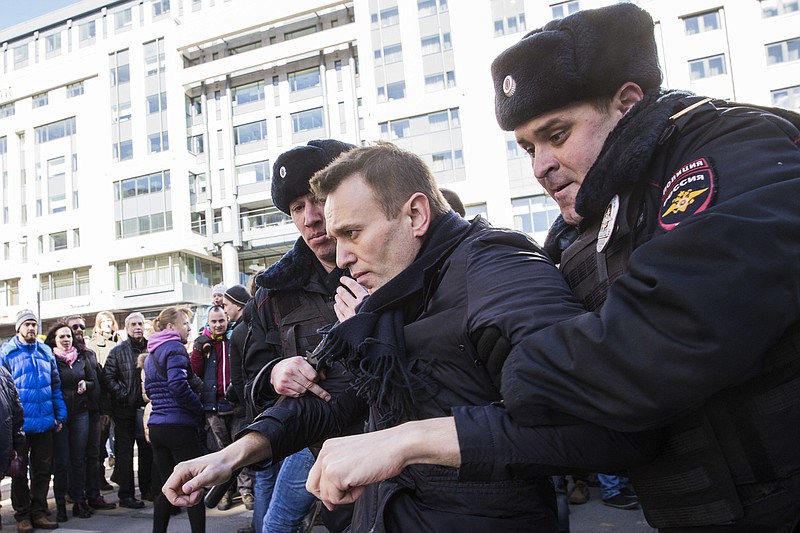 
              In this photo provided by Evgeny Feldman, Alexei Navalny is detained by police in downtown Moscow, Russia, Sunday, March 26, 2017. Russia's leading opposition figure Alexei Navalny and his supporters aim to hold anti-corruption demonstrations throughout Russia. But authorities are denying permission and police have warned they won't be responsible for "negative consequences" or unsanctioned gatherings. (Evgeny Feldman for Alexey Navalny's campaign photo via AP) MANDATORY CREDIT
            