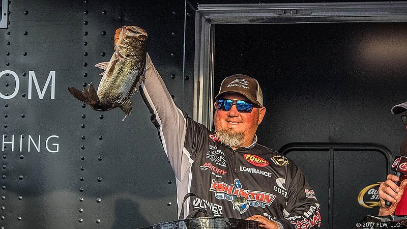 Buddy Gross holds up one of the bass he caught during a Fishing League Worldwide tournament.