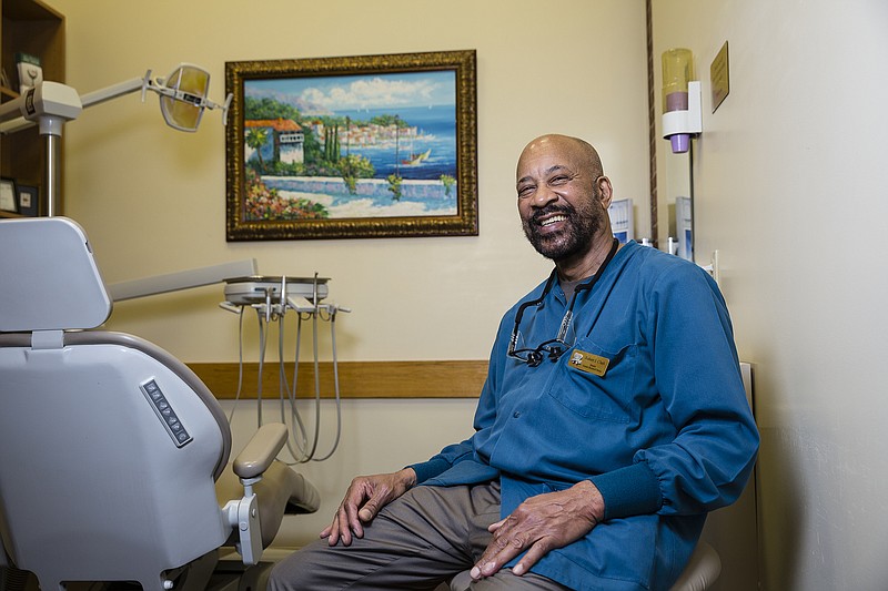 Dr. Robert Clark displays a large collection of original art in his office, Greater Brainerd Dental. The 65 pieces all have personal meaning to Clark, such as the painting by his son shown in the background.