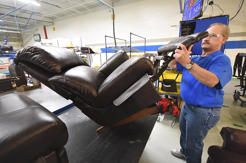 STEP 6 — Rick Johnson, quality technician, inspects operation of the recliner before moving it to shipping.