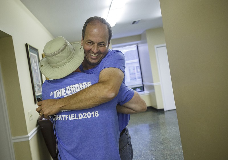 Then-candidate Shannon Whitfield, right, hugs a supporter after winning his Republican primary election for Walker County sole commissioner last May.