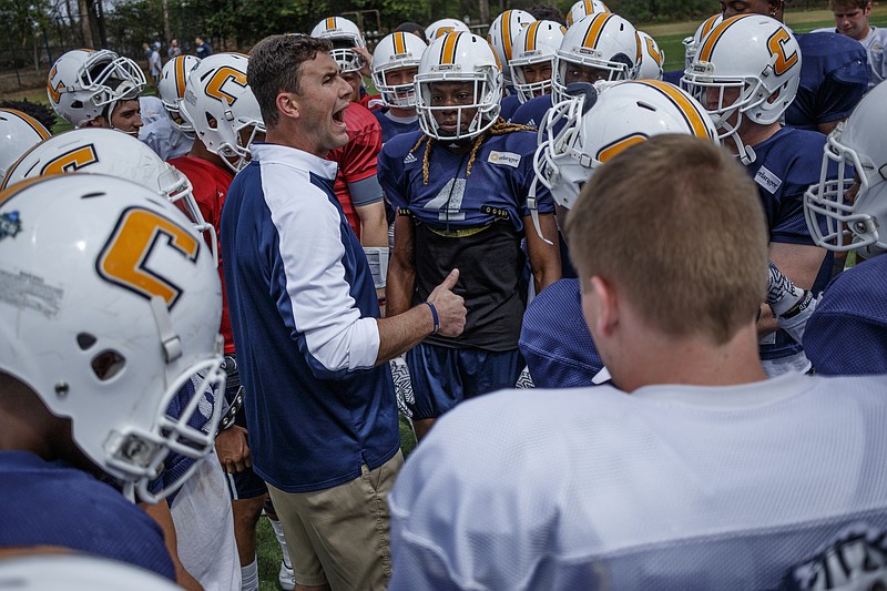 New UTC head football coach Tom Arth addresses the team at the start of practice Saturday at Scrappy Moore Field.