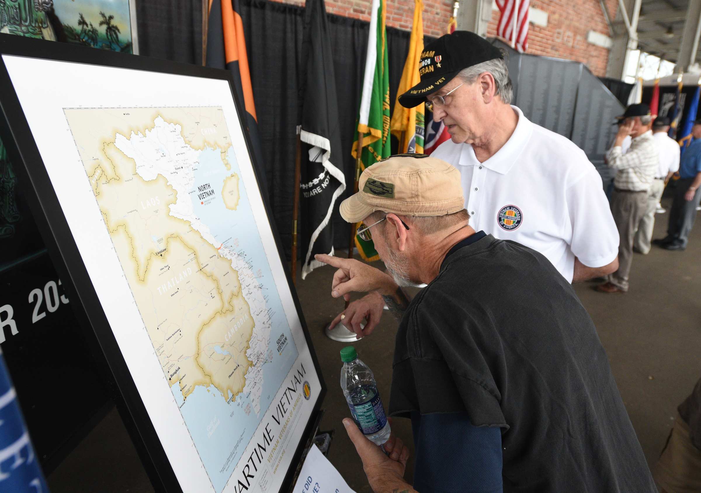 Mike Holden, right, helps Buck Cooper look Monday, March 27, 2017 during a Welcome Home celebration for Vietnam veterans at the First Tennessee Pavilion for the city where he served in the Vietnam War.