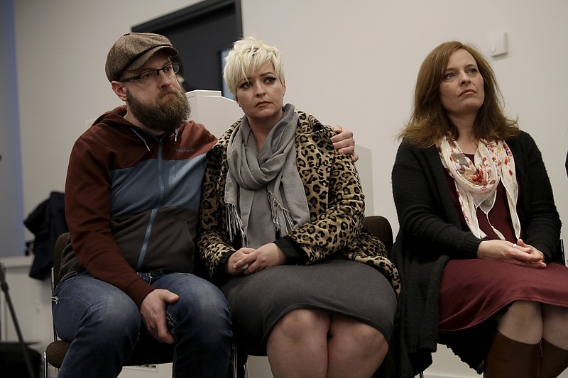 
              Sisters of U.S. tourist Melissa Cochran, who was injured and her husband Kurt Cochran killed in Wednesday's London attack, Angela, right, and Sara McFarland, center, with her husband Jason McFarland, listen during a press conference with family members at New Scotland Yard, the headquarters of London's Metropolitan Police force, in London, Monday, March 27, 2017. Pictured listening are family members, Melissa's sisters Sara McFarland, second left, Jennifer Burton, third left, Angela, right, and Sara's husband Jason McFarland, left. (AP Photo/Matt Dunham)
            