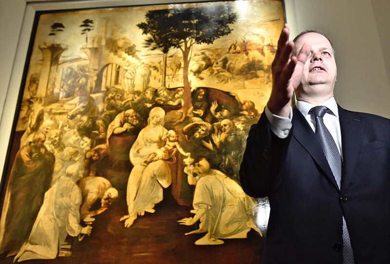 
              Uffizi museum manager Erik Smith gestures as Leonardo da Vinci’s "Adoration of the Three Wise Men" is returned to the public after 6 years of study and restoration, in Florence, Italy, Monday, March 27, 2017. Painted in 1481, it is one of the most important works of the early Leonardo. (Maurizio Degl' Innocenti/ANSA via AP)
            