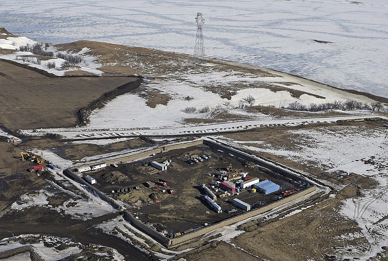 
              FILE- This Feb. 13, 2017, file aerial photo shows a site where the final phase of the Dakota Access Pipeline will take place with boring equipment routing the pipeline underground and across Lake Oahe to connect with the existing pipeline in Emmons County in Cannon Ball, N.D. The Dakota Access pipeline developer said Monday, March 27, that it has placed oil in the pipeline under a Missouri River reservoir in North Dakota and that it's preparing to put the pipeline into service. (Tom Stromme/The Bismarck Tribune via AP, File)
            