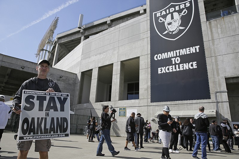 
              John P. Kelleher holds up a sign outside the Oakland Coliseum before the start of a rally to keep the Oakland Raiders from moving Saturday, March 25, 2017, in Oakland, Calif. NFL owners are expected to vote on the team's possible relocation to Las Vegas on Monday or Tuesday at their meeting in Phoenix. (AP Photo/Eric Risberg)
            