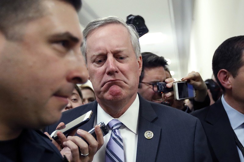 
              House Freedom Caucus Chairman Rep. Mark Meadows, R-N.C. reacts to a reporters question on Capitol Hill in Washington, Thursday, March 23, 2017, following a Freedom Caucus meeting. Just a few months ago, Republicans were cheering their good fortune, an all-Republican monopoly in Washington and the opportunity to push a conservative agenda to remake the federal government. After the health care vote, it’s clear winning can’t overcome the deep divisions in their ranks.  (AP Photo/Alex Brandon)
            