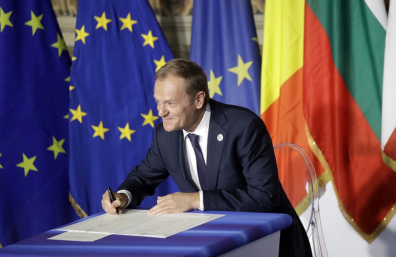 
              European Council President Donald Tusk signs a declaration during an EU summit meeting at the Orazi and Curiazi Hall in the Palazzo dei Conservatori in Rome on Saturday, March 25, 2017. European Union leaders were gathering in Rome to mark the 60th anniversary of their founding treaty and chart a way ahead following the decision of Britain to leave the 28-nation bloc. (AP Photo/Alessandra Tarantino)
            